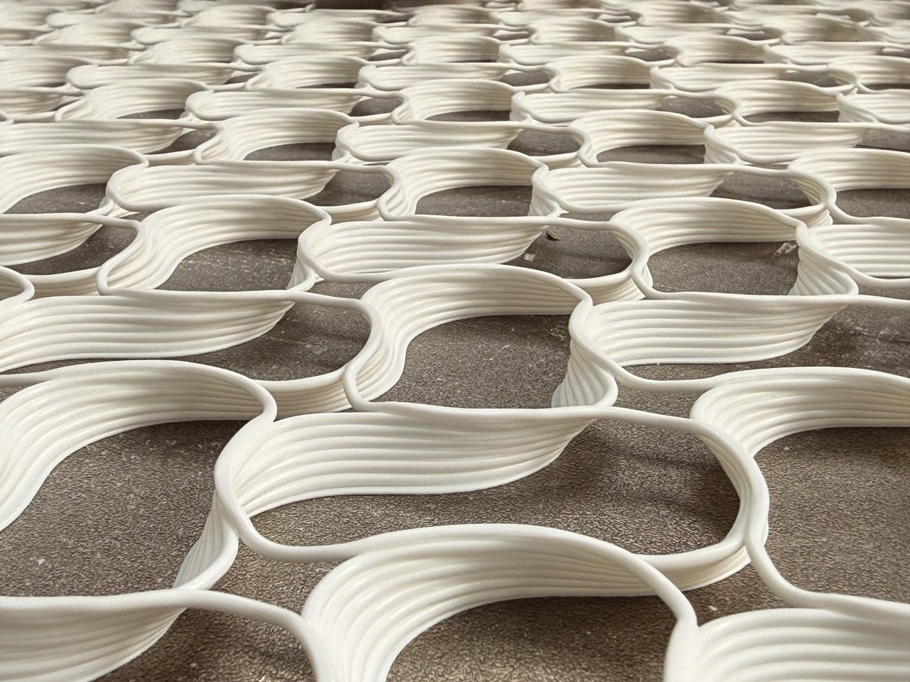ORIGEN architectural surface — handprinted lattice panel at the studio, an example of what members can custom-commission