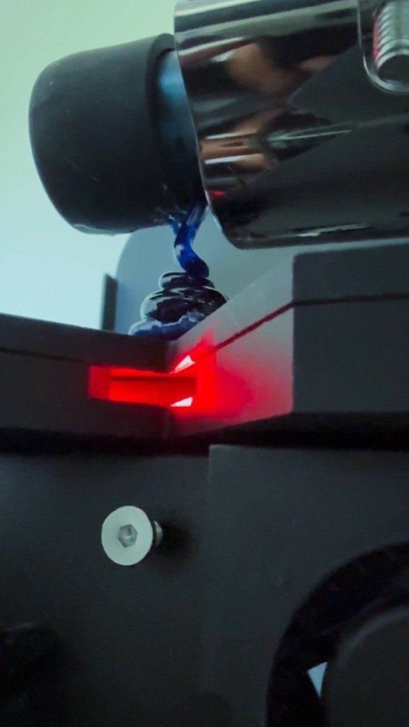 Filament extrusion in action — heated nozzle drawing 1.75 mm strand